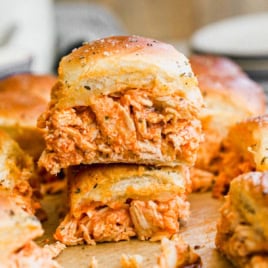 two cheesy buffalo chicken sliders on Hawaiian rolls