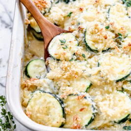 A wooden spoon serving a piece of zucchini casserole
