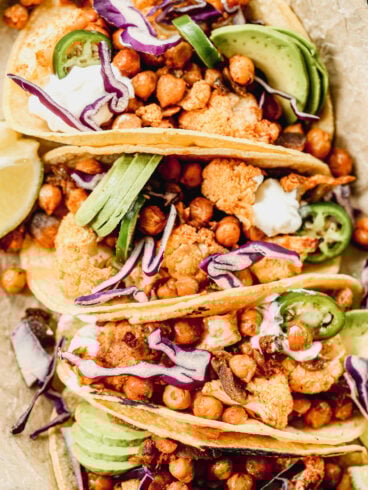 Crispy Cauliflower Tacos with chickpeas topped with avocado, jalapeno, and red cabbage