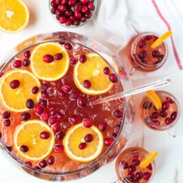 Easy, refreshing, DELICIOUS Sparkling Christmas Punch for a crowd! With champagne, rum, cranberry, and apple cider. Not to sweet, spiked, and so red and festive! Recipe includes nonalcoholic option.