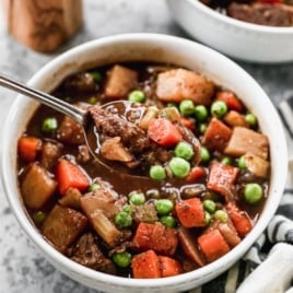 The BEST Crock Pot Beef Stew ever in a bowl with a spoon