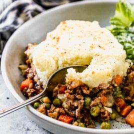 easy shepherds pie topped with mashed potatoes in a bowl with a spoon
