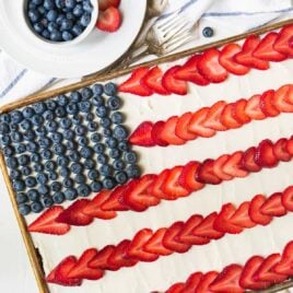 American Flag Cake. Made with REAL ingredients! From scratch fluffy yellow sheet cake, topped with Greek yogurt cream cheese frosting, fresh strawberry, and blueberry to look like an American flag. The perfect patriotic dessert recipe for the Fourth of July, Memorial Day, and Labor Day. Recipe at wellplated.com | @wellplated