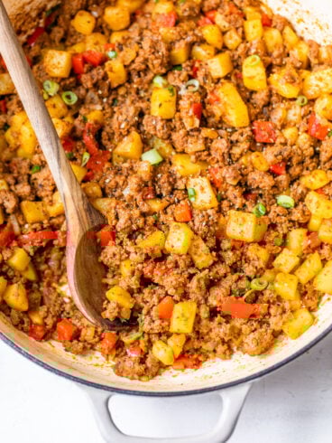 Ground beef and potatoes with red peppers in a pot