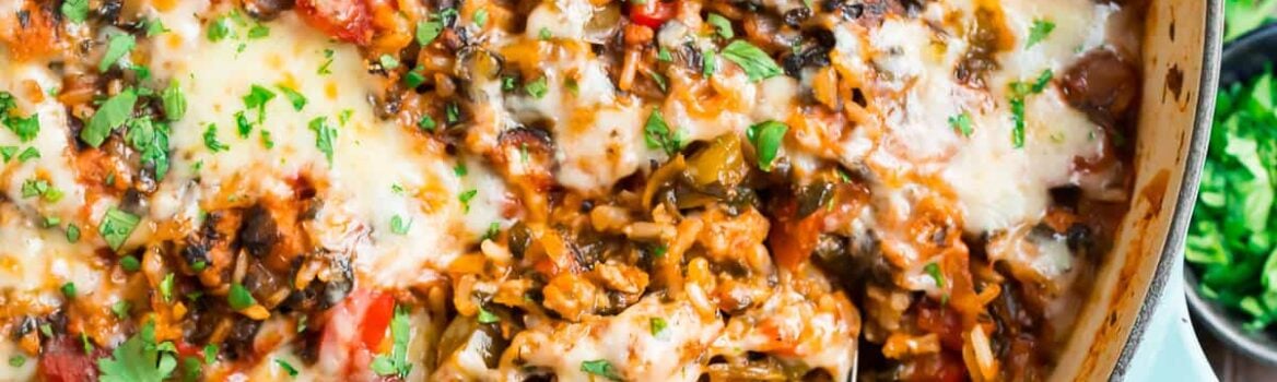 Stuffed Pepper Casserole with cheese, meat, bell peppers, and tomatoes in a skillet with cheese on top.