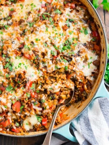 Stuffed Pepper Casserole with cheese, meat, bell peppers, and tomatoes in a skillet with cheese on top.