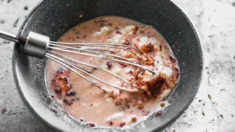 whisking creamy sauce for salmon bowls