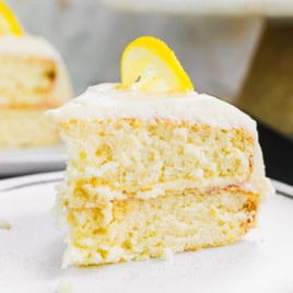 Slice of lemon layer cake on white plate