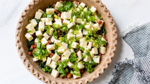 cheese, vegetables, and ham in a crust for quiche