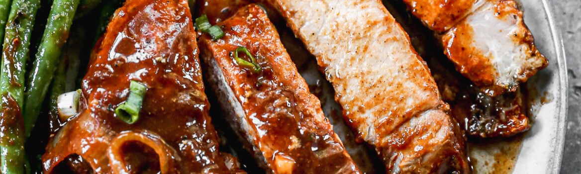 sliced juicy crockpot pork chops on a plate